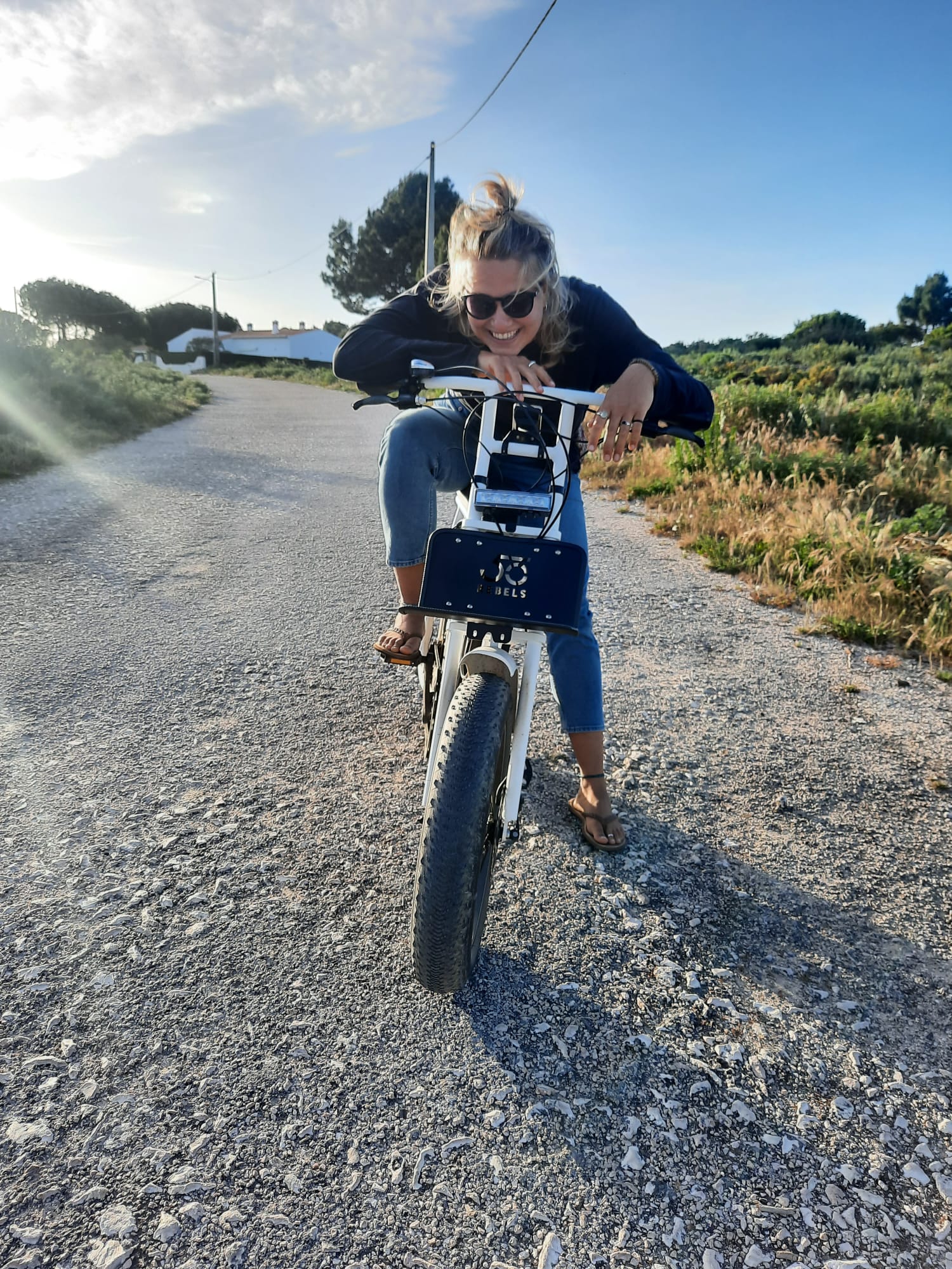 Girl on an e-fat ebike on the road near Carrapateira